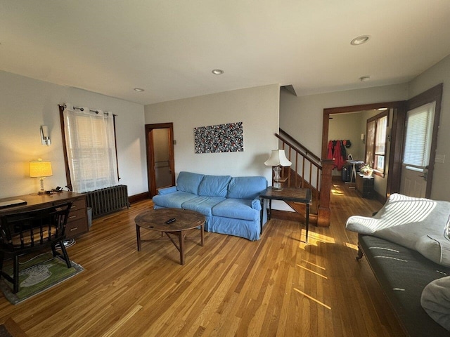 living room with hardwood / wood-style flooring and radiator