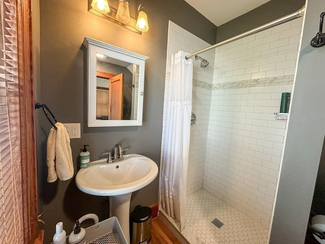 bathroom with curtained shower and sink