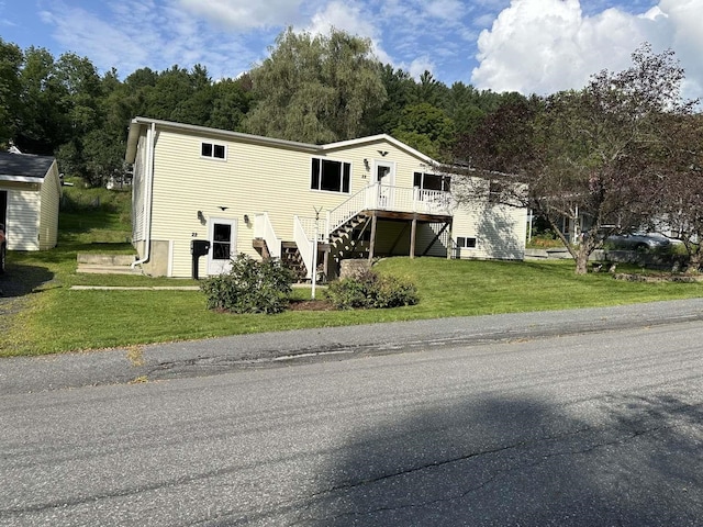 view of front of house with a front lawn and a wooden deck