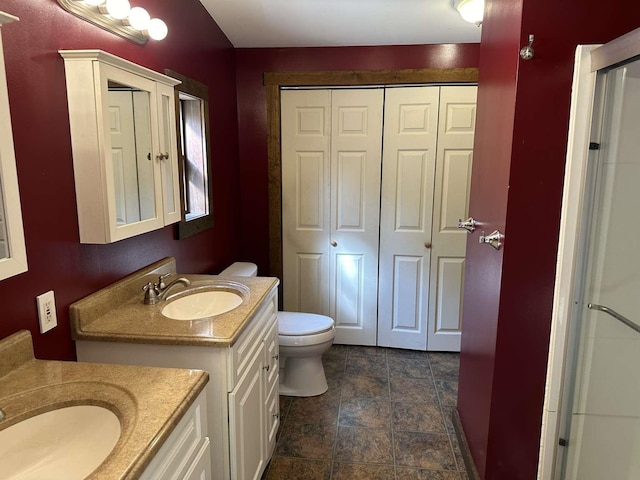 bathroom featuring toilet and vanity