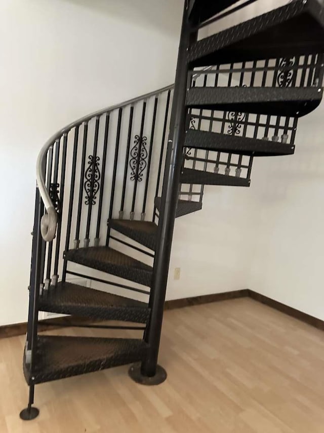 staircase with hardwood / wood-style flooring