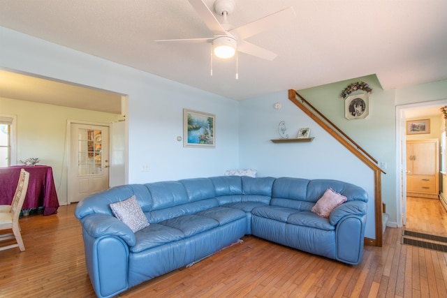 living room featuring hardwood / wood-style flooring and ceiling fan