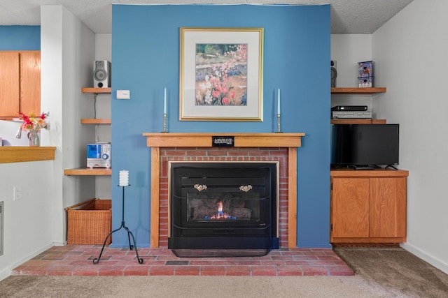 interior details with a textured ceiling, a brick fireplace, and carpet floors