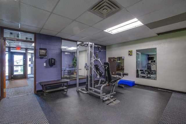 exercise room with a paneled ceiling