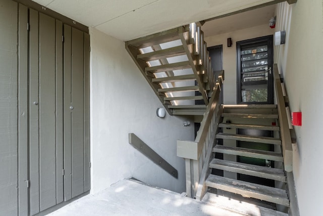 stairway featuring concrete flooring