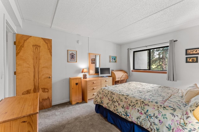 carpeted bedroom featuring a textured ceiling