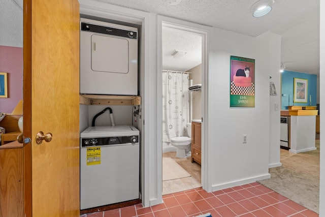 laundry area with a textured ceiling, stacked washer / drying machine, and carpet