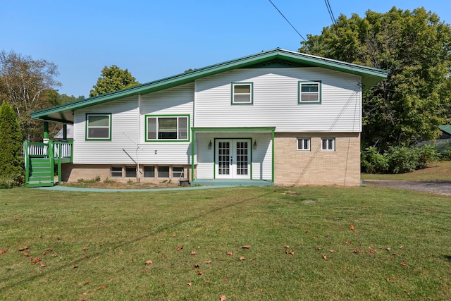 view of front of house featuring a front yard and french doors