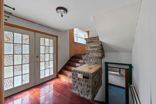 stairs featuring plenty of natural light and hardwood / wood-style flooring