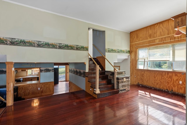 living room featuring wood-type flooring and wooden walls