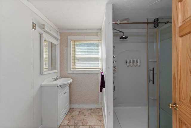 bathroom with a shower with door and vanity