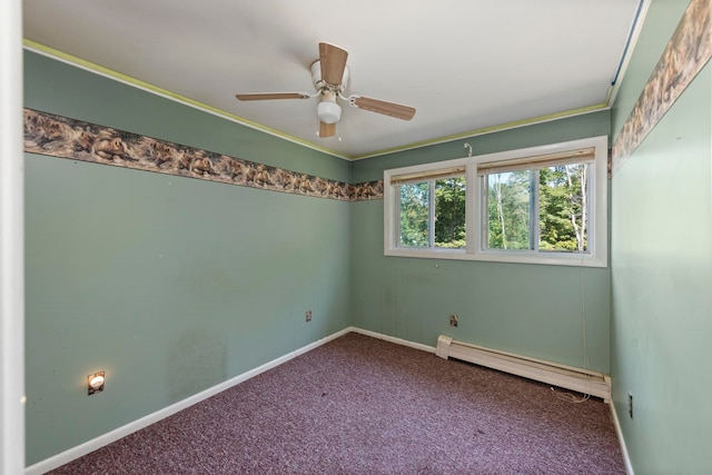 carpeted spare room featuring a baseboard heating unit, crown molding, and ceiling fan