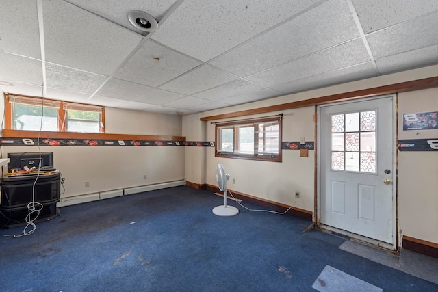 foyer entrance with carpet, baseboard heating, and a drop ceiling