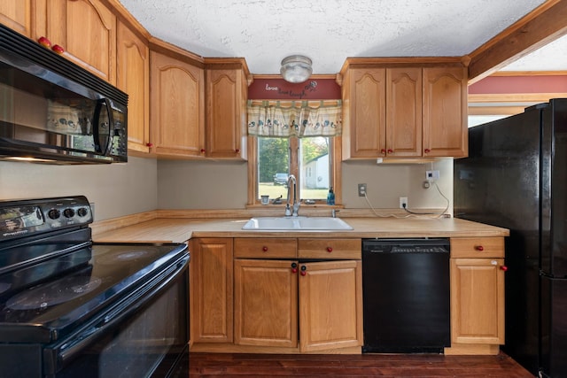 kitchen featuring black appliances, a textured ceiling, sink, and dark hardwood / wood-style floors