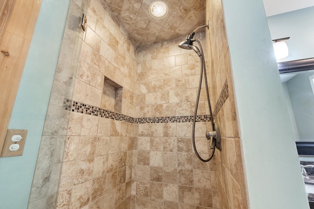 full bathroom with a tile shower