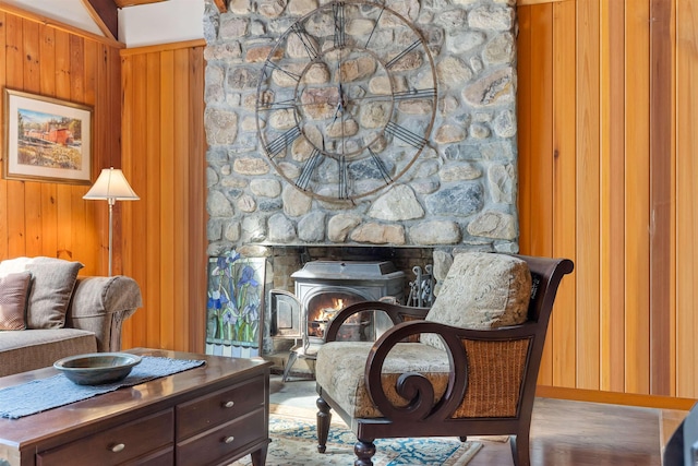 living area with wood finished floors, wood walls, and baseboards