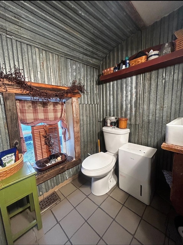 bathroom with toilet and tile patterned floors