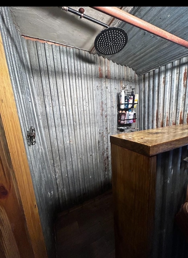 bar featuring wooden counters and wooden walls