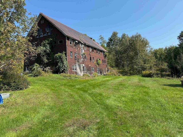 rear view of property with a yard