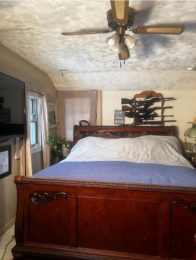 bedroom featuring ceiling fan, light carpet, and a textured ceiling