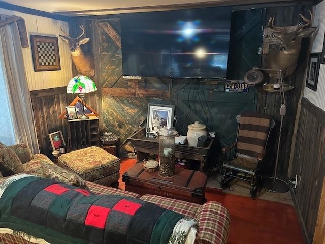 bedroom featuring wooden walls