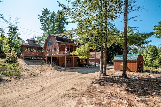 359 Gold Coast Dr, Wakefield, NH 03830 - rear view of property with a gazebo, a gambrel roof, a storage shed, an outbuilding, and a wooden deck