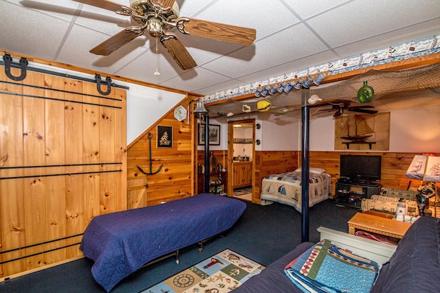 359 Gold Coast Dr, Wakefield, NH 03830 - bedroom with carpet flooring, wood walls, a barn door, a wainscoted wall, and a drop ceiling