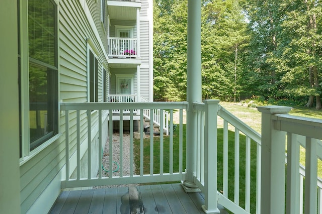 wooden terrace with a lawn