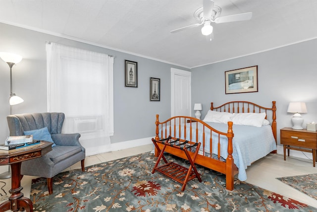 bedroom with ceiling fan and crown molding