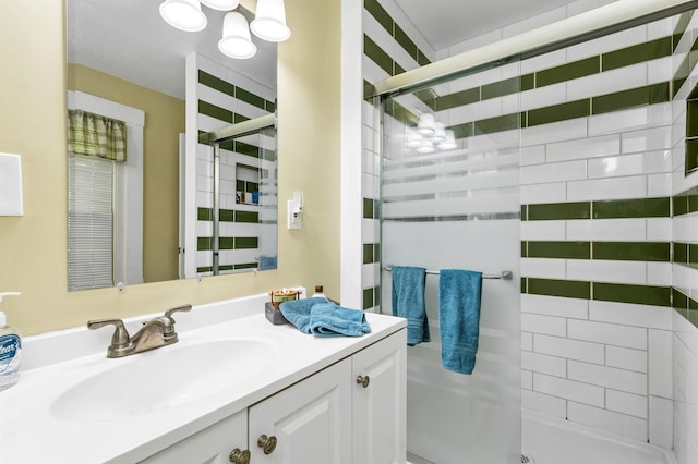 bathroom featuring walk in shower and vanity