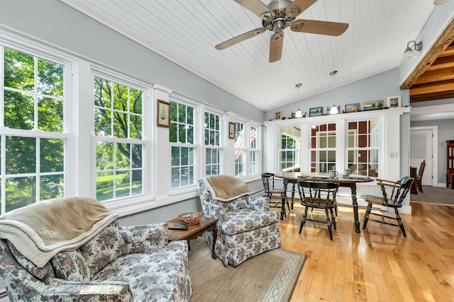 sunroom / solarium with wood ceiling, lofted ceiling, ceiling fan, and a wealth of natural light