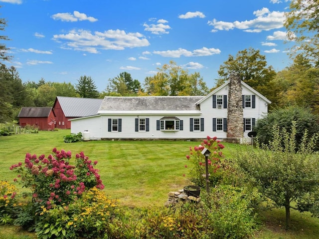 rear view of house featuring a yard