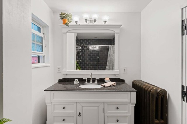 bathroom featuring vanity, radiator, and a shower with curtain