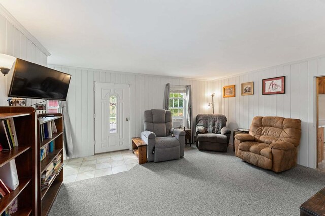 living room with light carpet and ornamental molding