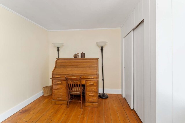 office space with ornamental molding and hardwood / wood-style floors