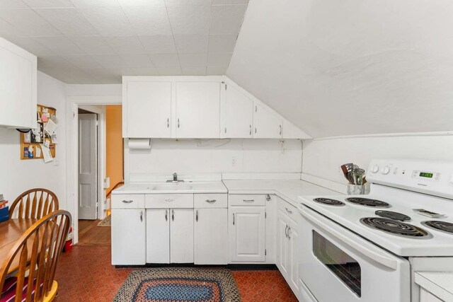 kitchen with white cabinetry, electric stove, and sink