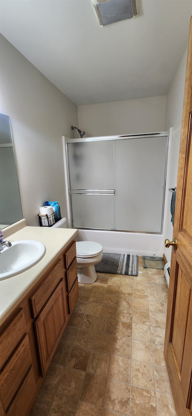 full bathroom with vanity, toilet, and combined bath / shower with glass door