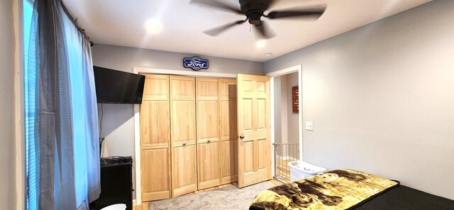 bedroom featuring ceiling fan, wood-type flooring, and a baseboard heating unit