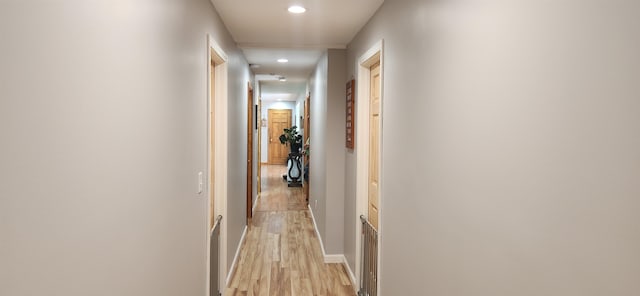 corridor with light hardwood / wood-style floors