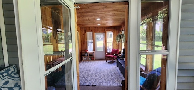 sunroom featuring wooden ceiling and a healthy amount of sunlight