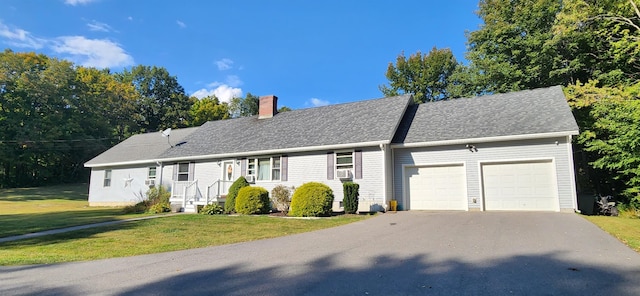 view of front of house with a garage and a front lawn