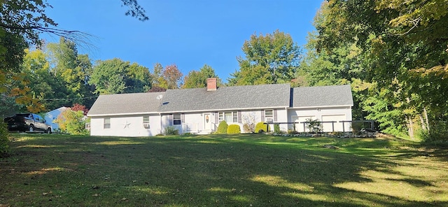 rear view of house with a yard