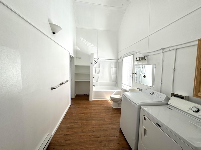 laundry area featuring a high ceiling, dark hardwood / wood-style floors, and washer and dryer