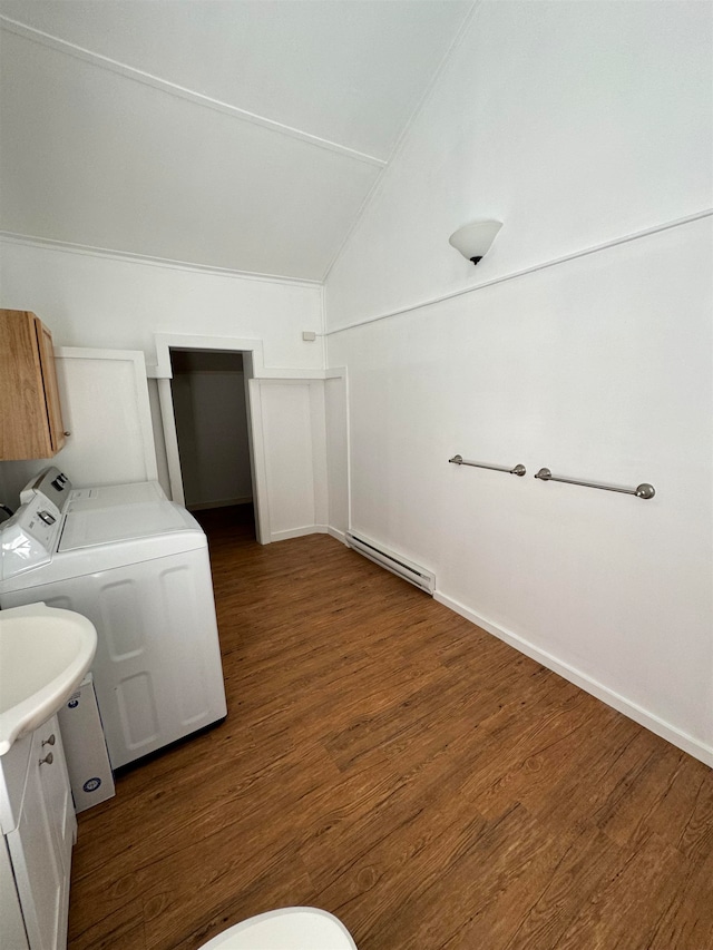 clothes washing area featuring washer and dryer, dark hardwood / wood-style floors, a baseboard heating unit, and sink