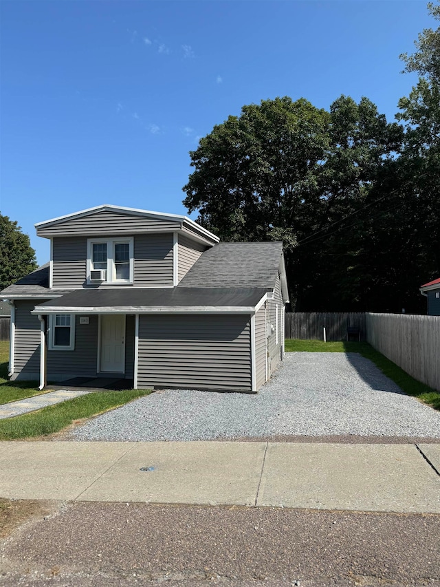 view of front of house with cooling unit and a garage