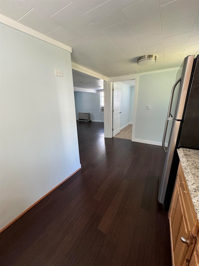 corridor featuring ornamental molding and dark hardwood / wood-style flooring