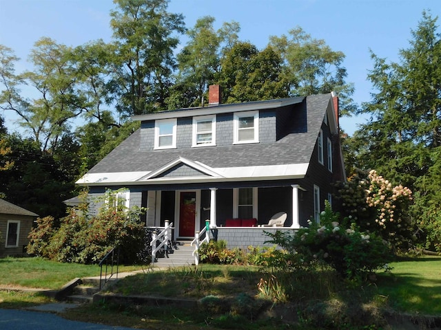 view of front of home featuring a porch and a front lawn