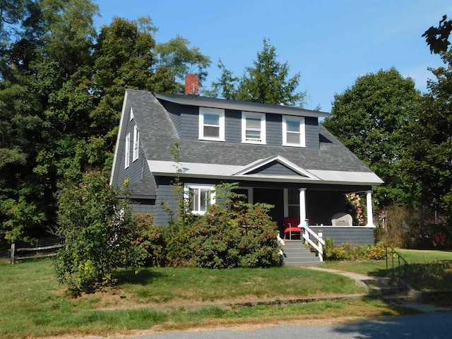 view of front of home featuring covered porch and a front lawn