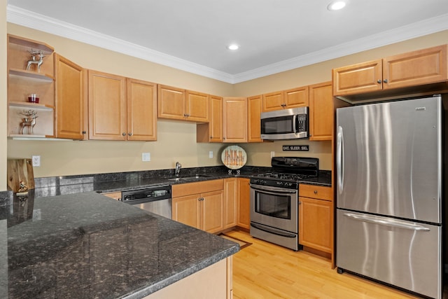 kitchen with appliances with stainless steel finishes, crown molding, dark stone countertops, and light wood-type flooring