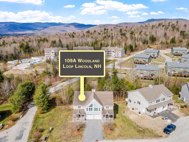 birds eye view of property featuring a mountain view